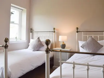a bedroom with two beds and a window at Craigmore View-Uk34220 in Aberfoyle