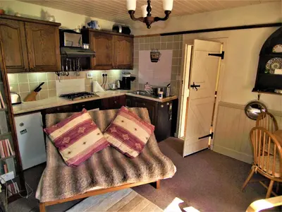 a kitchen with a couch with two pillows on it at Tigh Na Maraiche in Isle of Jura