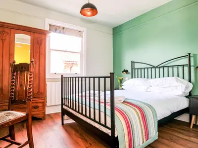 a bedroom with a bed and a window and a crib at Holst Apartment in Newton Stewart