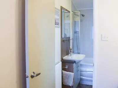 a bathroom with a sink and a mirror at Riverside Lodge in Auchterarder