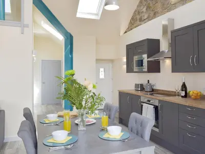 a kitchen and dining room with a table and chairs at Uk7385 - Chaff House in Newmilns