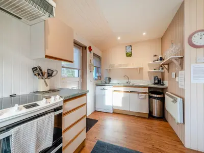 a kitchen with white cabinets and a sink at The Creagan in Corrie