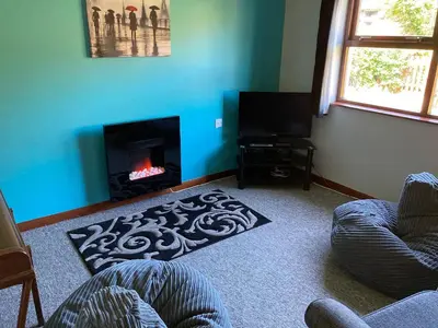 a living room with a couch and a fireplace at Westlin in Penpont