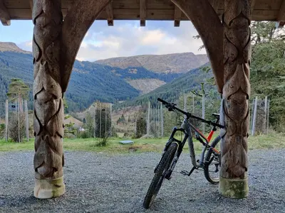 a bike is parked under a wooden structure at Willow Lodge in Rashfield