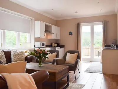 a living room with a table and chairs at Forth View-Uk34217 in Aberfoyle