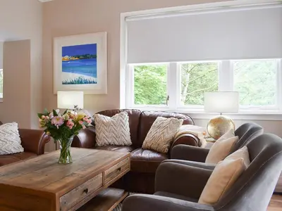 a living room with a couch and a table at Forth View-Uk34217 in Aberfoyle