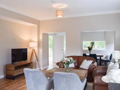 a living room with a couch and a table at Forth View-Uk34217 in Aberfoyle