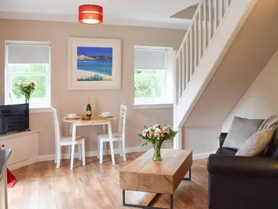 a living room with a couch and a table at Faodail-Uk34218 in Aberfoyle