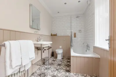 a bathroom with a sink and a tub and a toilet at Victoria Square & The Orangery in Stirling
