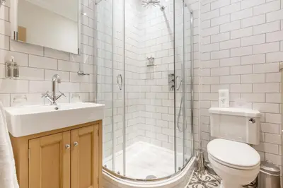 a bathroom with a toilet and a sink and a shower at Victoria Square & The Orangery in Stirling