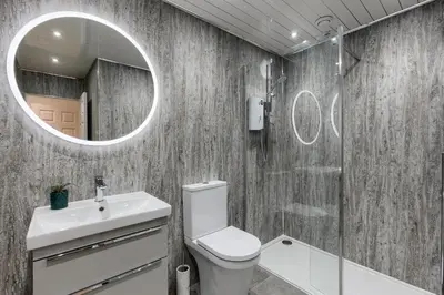 a bathroom with a toilet and a sink and a mirror at 3 bedroom Windsor Garden apartment by Gleneagles in Blackford