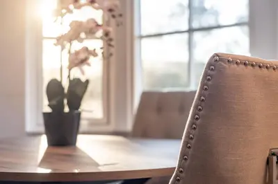 a table with a vase with a plant on it at 3 bedroom Windsor Garden apartment by Gleneagles in Blackford
