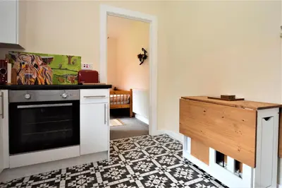 a kitchen with a stove and a counter top at Nursery Cottage Benmore in Benmore
