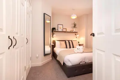 a bedroom with a bed and a large mirror at JOIVY Modern 1 bed Flat in West End, close to Princes Gardens in Edinburgh
