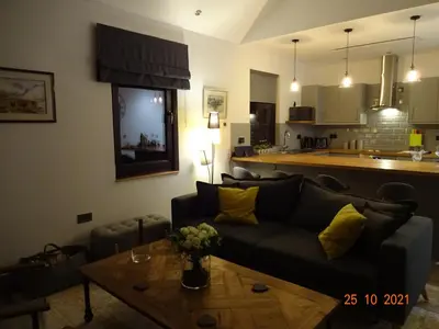 a living room with a couch and a table at The Stables near Glasgow in Balmore