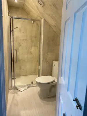 a small bathroom with a toilet and a shower at West Loch House in West Tarbert