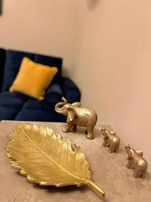 a table with a gold leaf and figurines of elephants at 1 bed Apt in West End in Glasgow