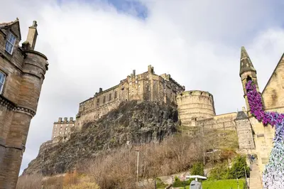 a castle sitting on top of a mountain at JOIVY Charming Home with Patio Nearby the Castle in Edinburgh