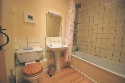 a bathroom with a toilet and a sink and a tub at Bonawe House Holiday Cottages in Taynuilt
