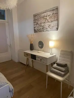 a desk with a lamp and a chair in a room at Dunoon River Clyde Flat in Innellan