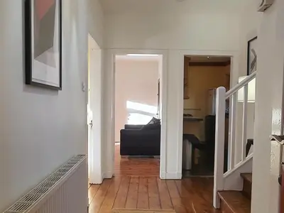 an open hallway with a couch in a living room at Large 3 Bed Apartment Glasgow West End Free Parking & Electric Vehicle point in Glasgow