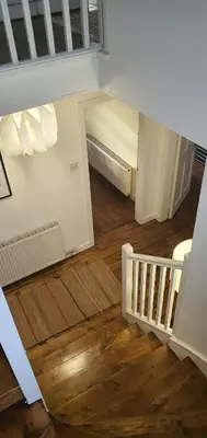 an empty room with a staircase and wood floors at Large 3 Bed Apartment Glasgow West End Free Parking & Electric Vehicle point in Glasgow