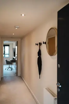 a mirror and an umbrella hanging on a wall at West End Escape - Prime Location in Glasgow