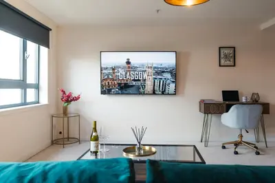 a living room with a couch and a glass table at West End Escape - Prime Location in Glasgow