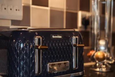 a black toaster sitting on a kitchen counter at City View - A Stunning 2 Bed Apartment in Glasgow