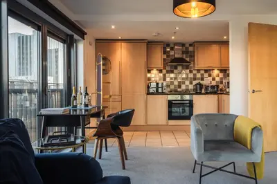 a kitchen with a table and chairs in a room at City View - A Stunning 2 Bed Apartment in Glasgow