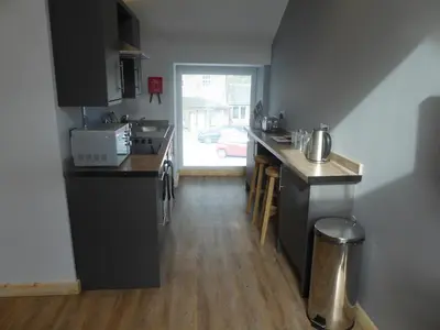 a kitchen with a sink and a counter top at Auchendennan Farm Self Catering Cottages in Balloch