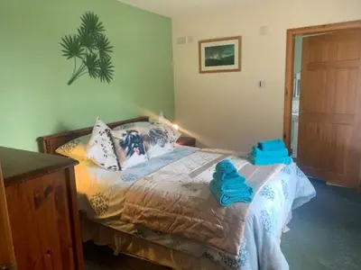 a bedroom with a bed with blue towels on it at Snowberry Cottages No1 in Onich