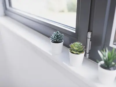 three potted plants sitting on a window sill at Lovely 2-Bed Flat Glasgow Harbour FREE parking - Pass the Keys in Glasgow