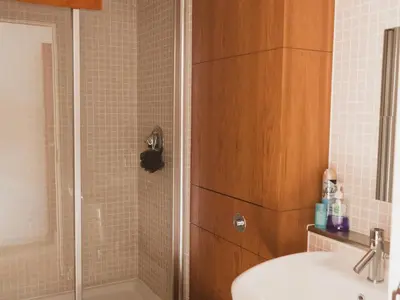 a bathroom with a shower with a sink and a toilet at Lovely 2-Bed Flat Glasgow Harbour FREE parking - Pass the Keys in Glasgow