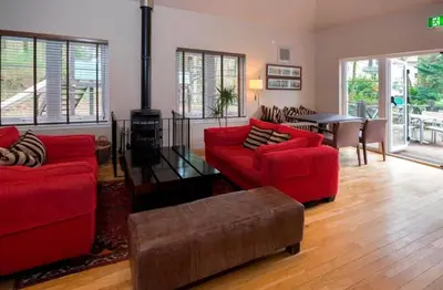 a living room with two red couches and a table at Ryder Cup Lodge Duchally - Free access to Leisure Club Swimming Pool Hot Tub Steam Room - Starlink Satellite Internet - Sky Glass Now DOG FRIENDLY for 2025 in Auchterarder
