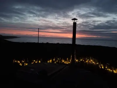a view of a beach with lights at night at North Muasdale Farm in Muasdale