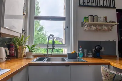 a kitchen with a sink and a window at Traditional apt close to city centre & Hampden in Glasgow