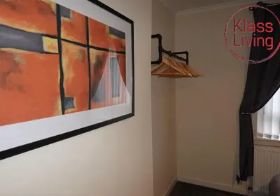 a painting hanging on a wall next to a window at Welsh Drive Apartment by Klass Living Blantyre in High Blantyre