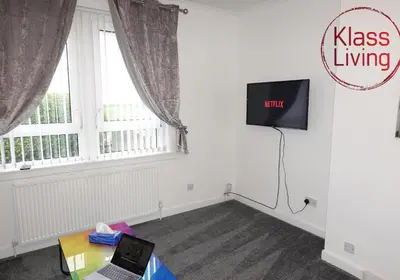 a room with a laptop on a table in front of a window at Welsh Drive Apartment by Klass Living Blantyre in High Blantyre