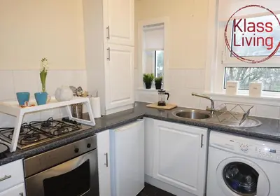 a white kitchen with a sink and a stove at Welsh Drive Apartment by Klass Living Blantyre in High Blantyre