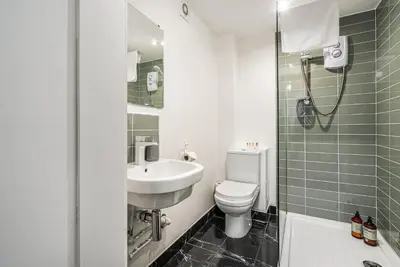 a bathroom with a sink and a toilet and a shower at Renfrew Residence Central Glasgow 4-Bed Flat in Glasgow
