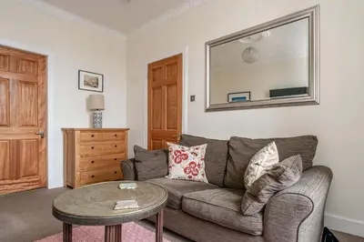 a living room with a couch and a table at amazing apartments - Torphichen Place by Haymarket in Edinburgh