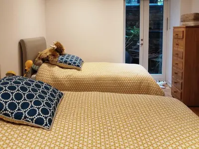 two beds sitting next to each other in a bedroom at Kilbowie Retreat in Oban