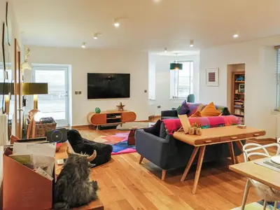 a living room with a cat sitting on the floor at Kilbowie Retreat in Oban