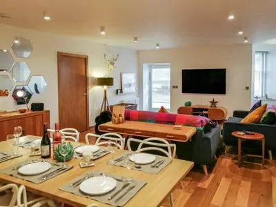 a living room with a couch and a table at Kilbowie Retreat in Oban