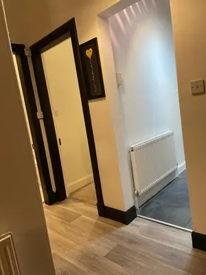 a hallway with a door and a mirror at Heart of George street / Oban / Argyll in Oban