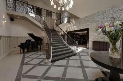 a staircase in a building with a table and chairs at Dumfries Arms Hotel in Cumnock