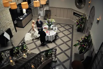 a bride and groom standing at a table in a room at Dumfries Arms Hotel in Cumnock