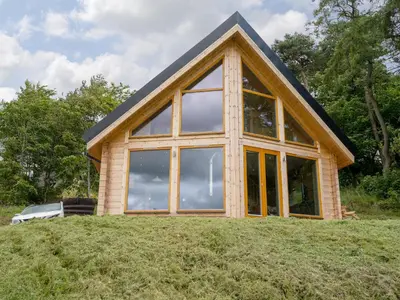 a house with a large window on a hill at Alban in Linlithgow
