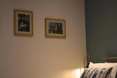 two pictures on the wall of a bedroom at Orchy Bank House in Dalmally
